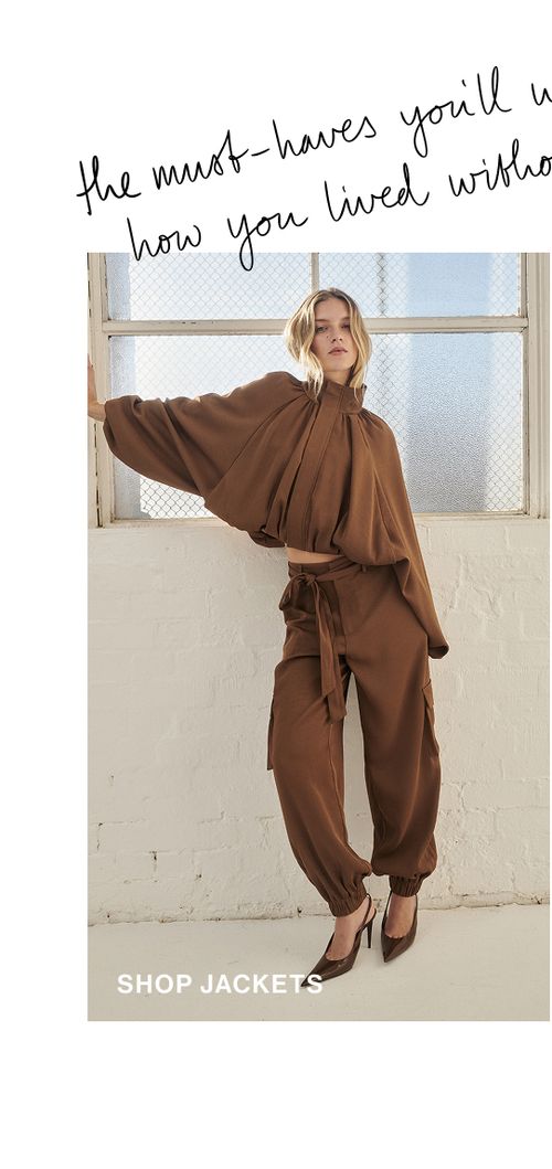 Model posing in a brown satin bubble jacket. SHOP JACKETS.
