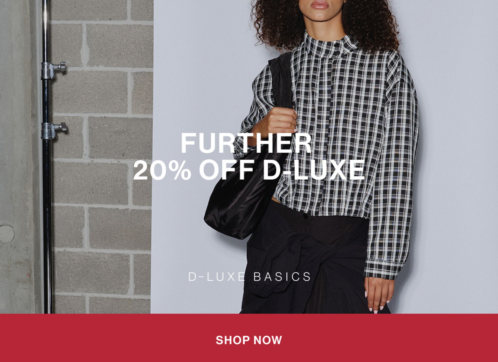 Model wearing a black check shirt in a studio. Text reads FURTHER 20% OFF D-LUXE.