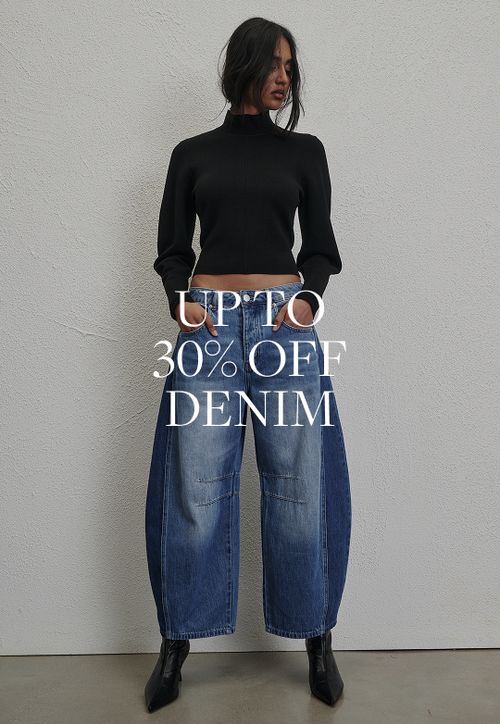 Model wearing a light denim jacket and jeans. SHOP DENIM.