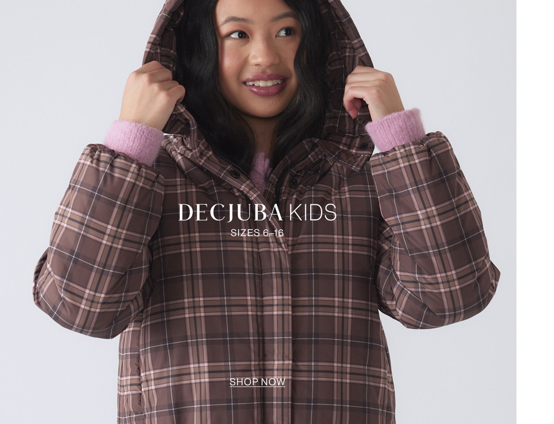 Image of young model wearing a gingham puffer jacket with text overlay: "DECJUBA KIDS SIZES 6-16"