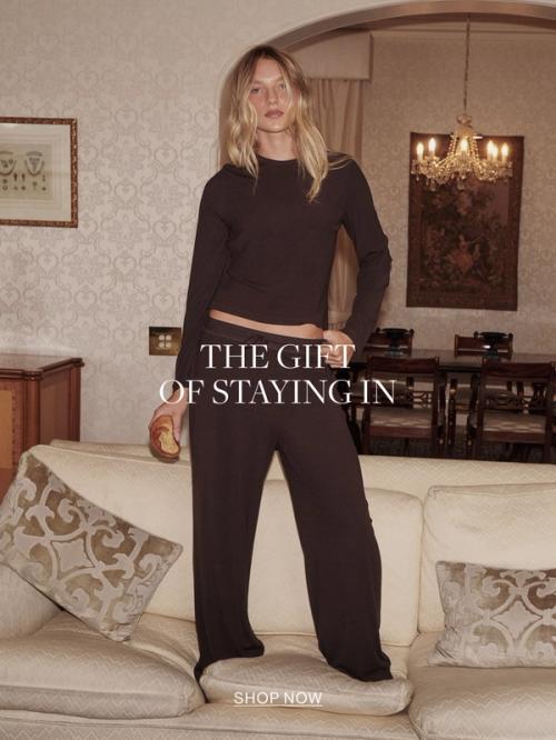Woman in chocolate sleep set. Text reads the gift of staying in