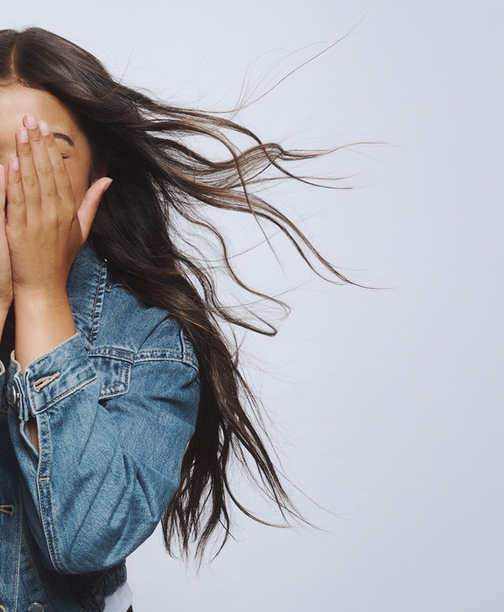 A young girl with her hands on her face