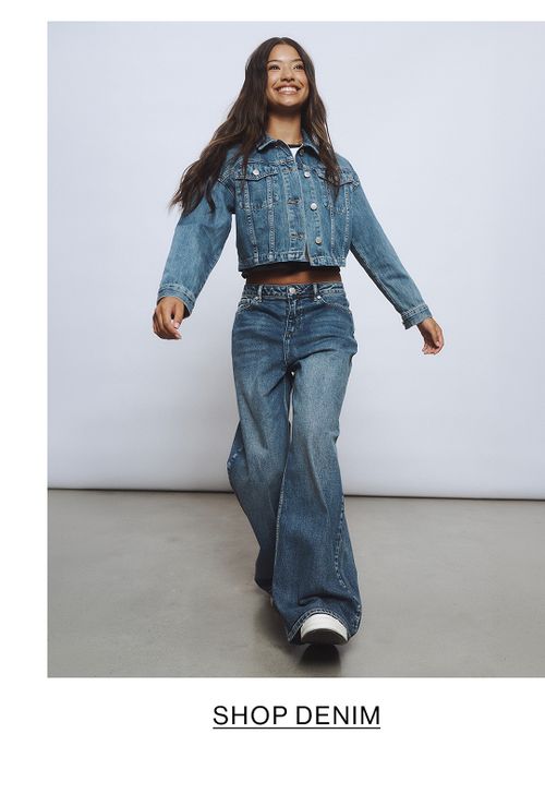 Young girl dressed in a white hoodie and matching sweatpants.