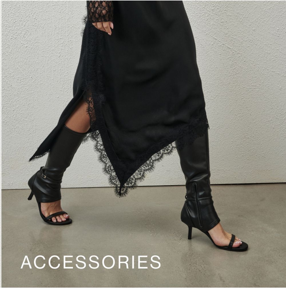 Model wearing a brown high neck long sleeve top with a brown shoulder bag. SHOP ACCESSORIES.