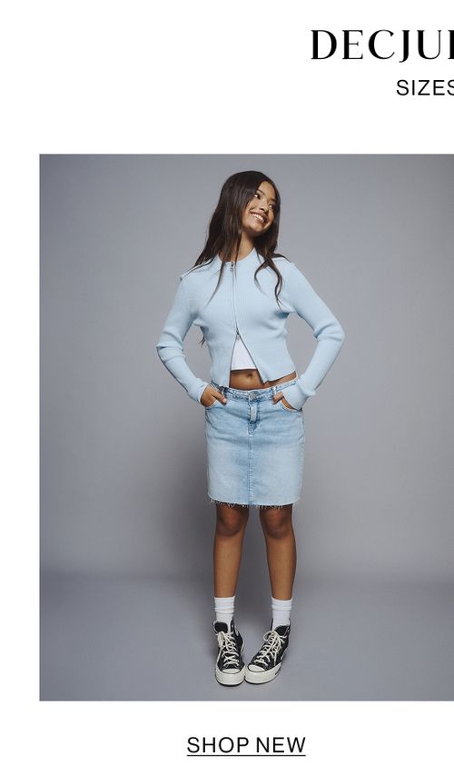 Young girl wearing a light blue denim jacket and skirt set.