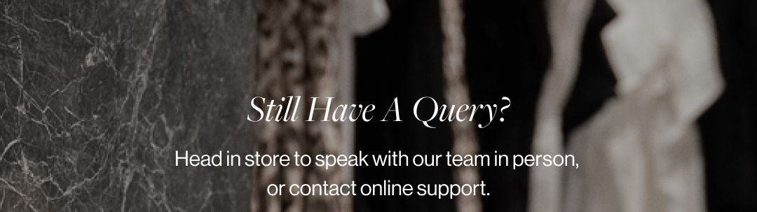 A blurred photo of a clothing store with the text "Still Have a Query?"