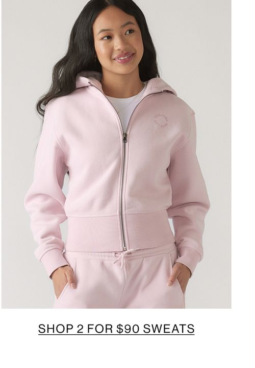 Model wearing a matching pink set with text that states shop 2 for $90 sweats