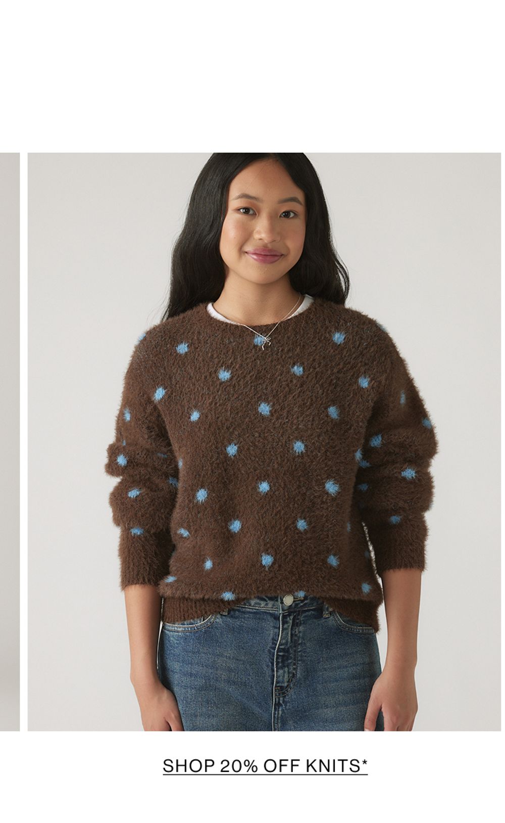 Young model wearing a brown knit with blue polka dots. SHOP 20% OFF TEEN GIRLS KNITWEAR.