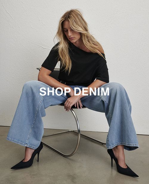 Model wearing sparkly denim jeans. Text reads SHOP DENIM