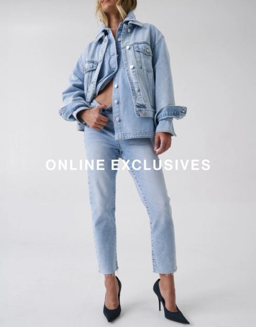 Jess Hart standing in blue slim-fit jeans with a cropped blue jacket, hand in pocket. SHOP ONLINE EXCLUSIVES