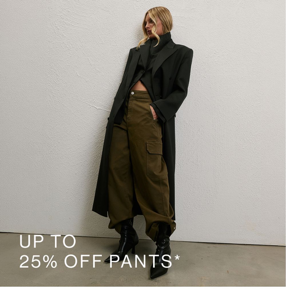 Woman in khaki cargo pants set against a neutral background. SHOP 25% OFF PANTS.