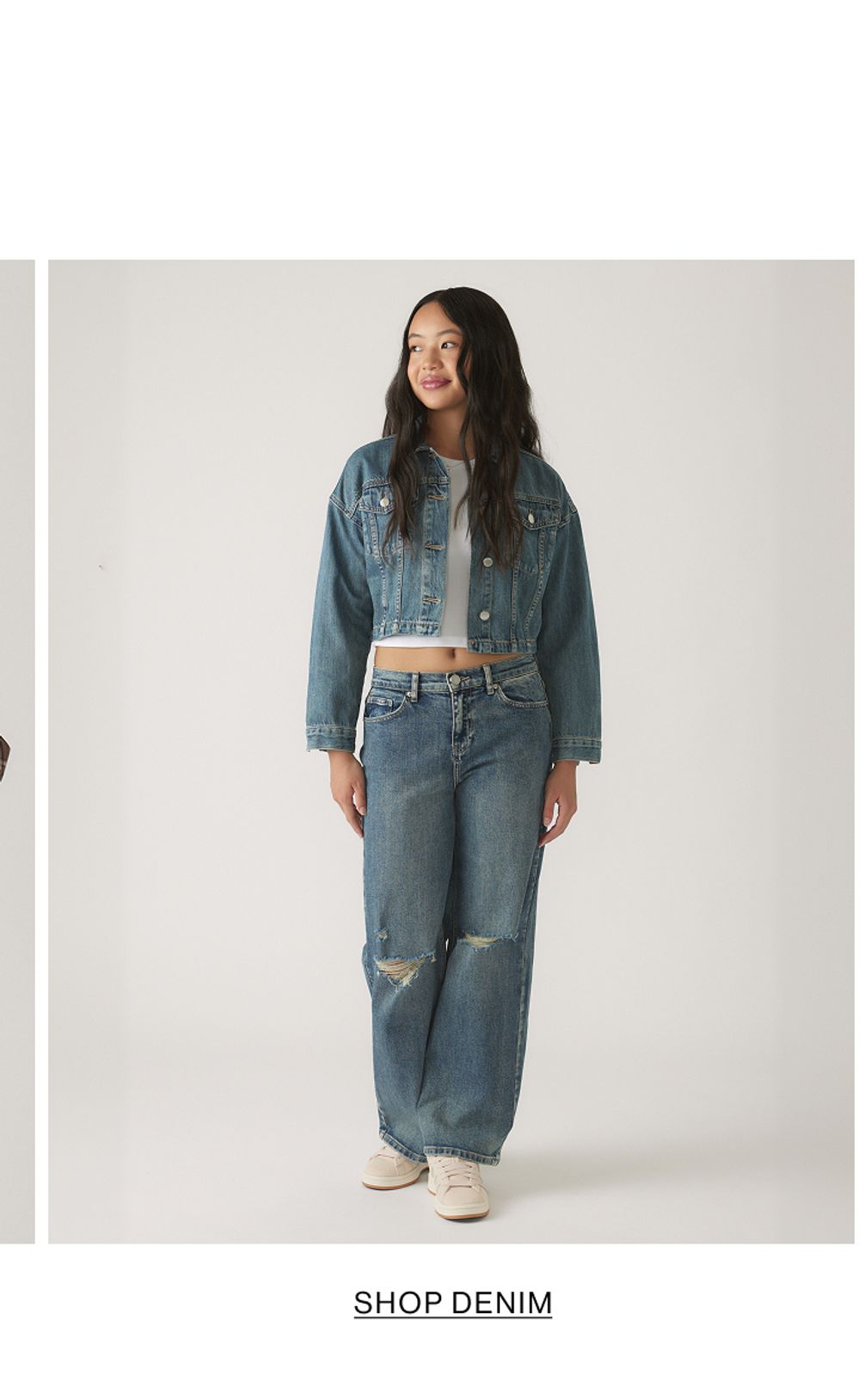 Girl wearing denim on denim with text that states "Shop Denim"