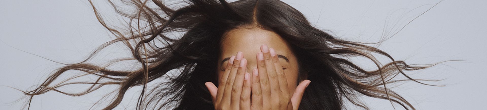 A young girl with her hands on her face