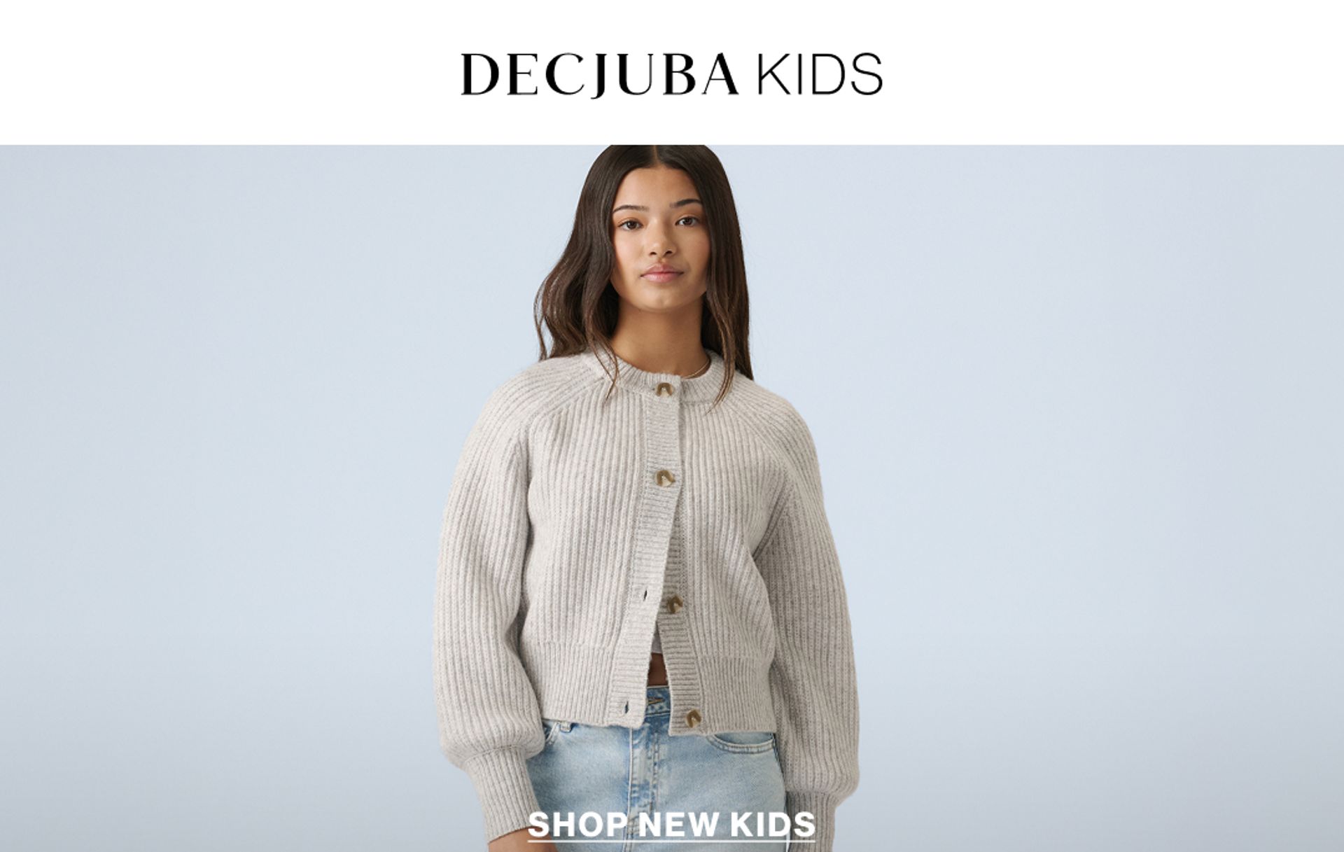 Model wearing a stripe knit in a studio. Text reads DECJUBA KIDS