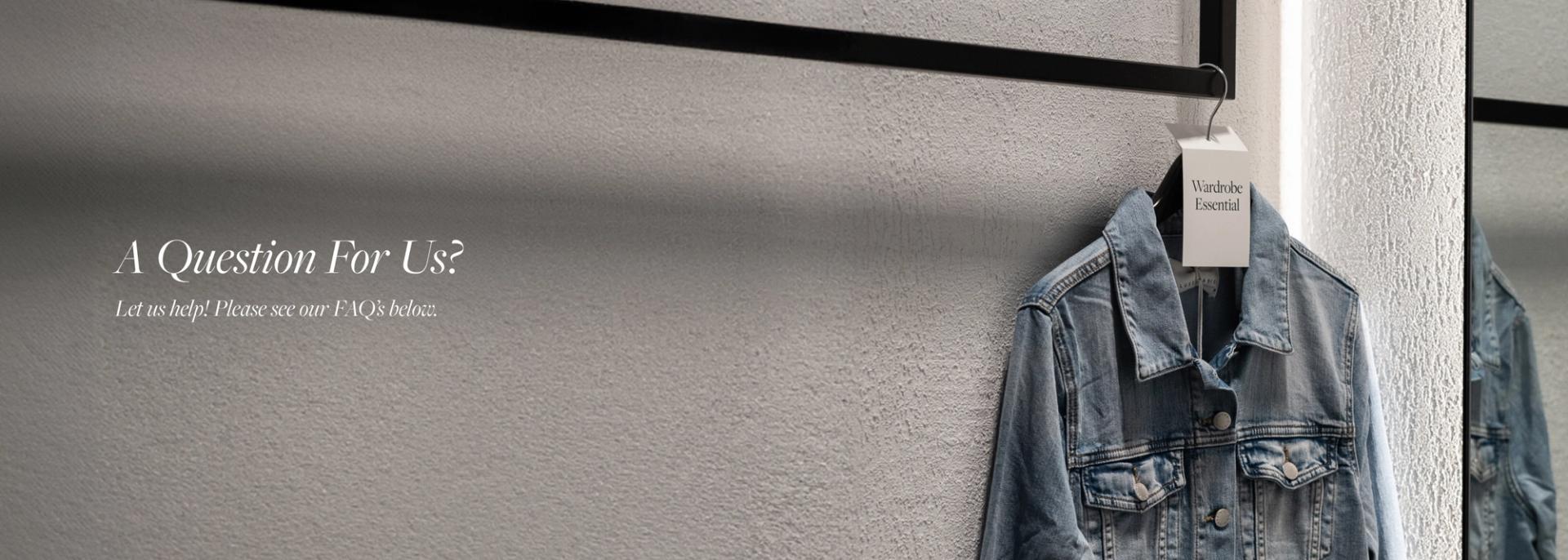A denim jacket hanging on a clothing rail on a grey wall with the text "A Question For Us?"