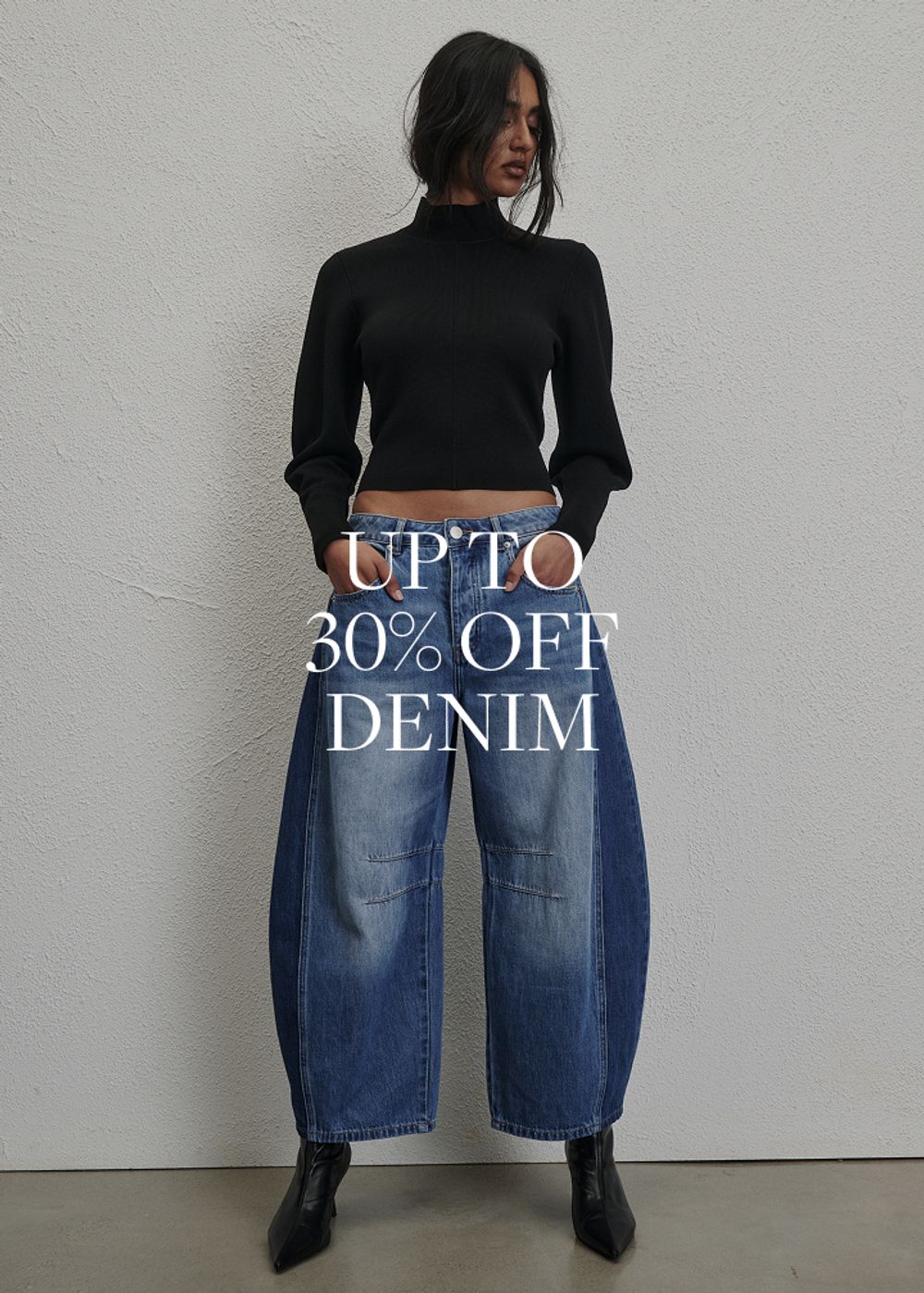 Model wearing a light denim jacket and jeans. SHOP DENIM.