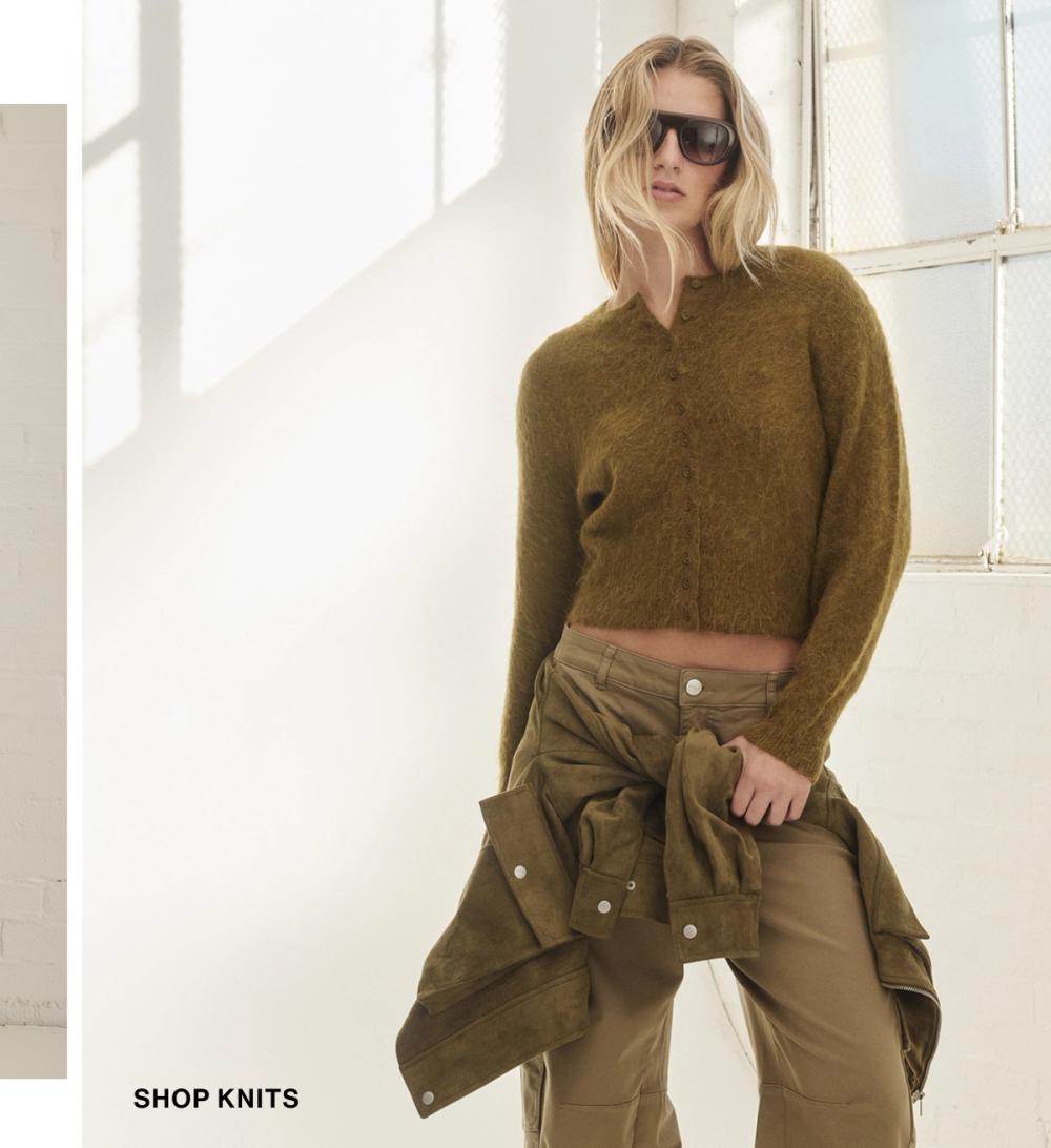 Model wearing a chartreuse knit cardigan. SHOP KNITS.