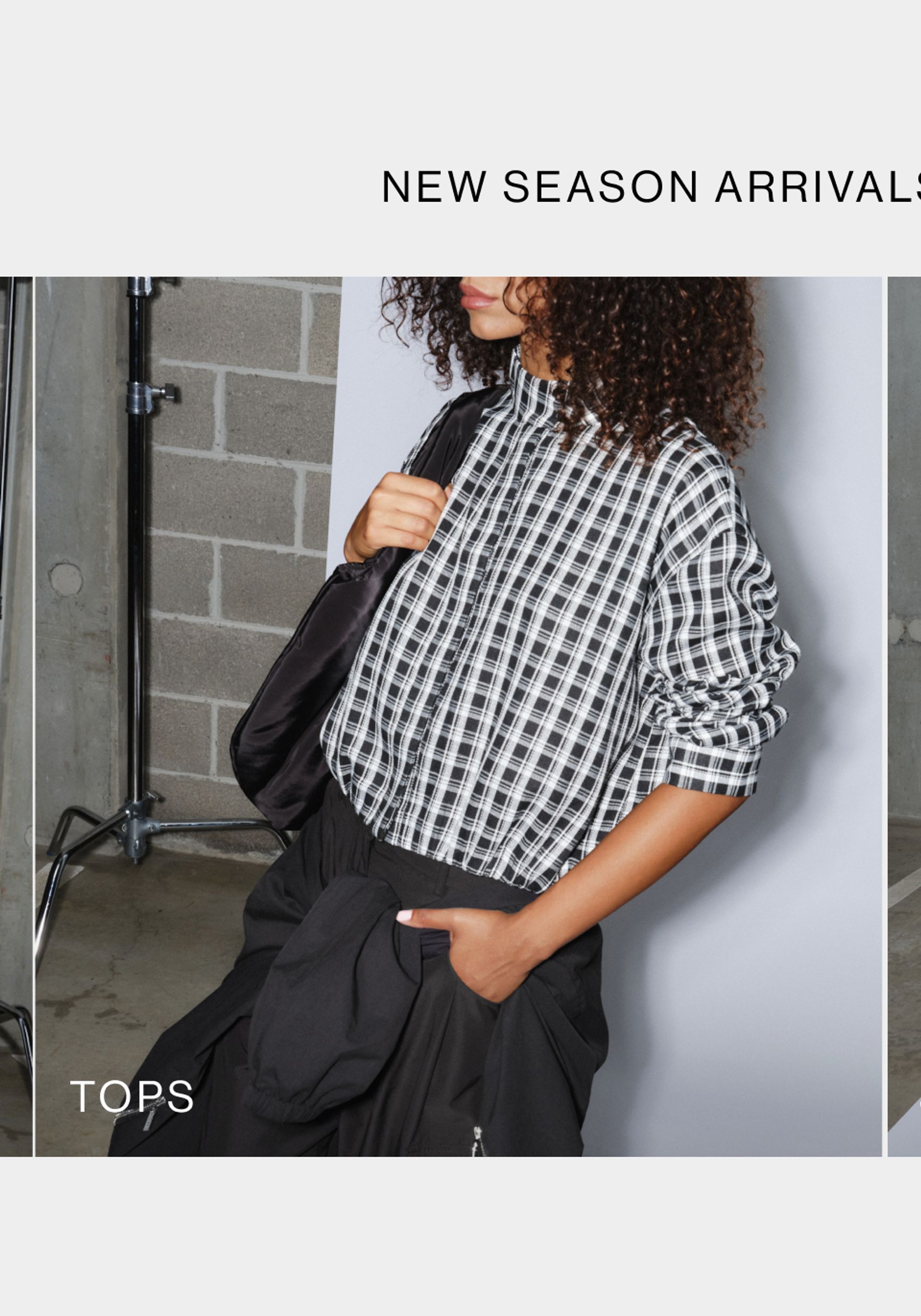 Model wearing a white and black check print shirt. SHOP D-LUXE TOPS.