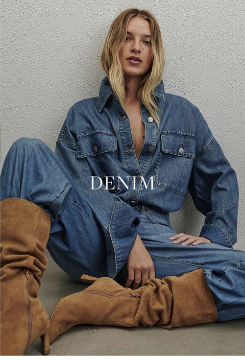Model wearing a light denim jacket and jeans. SHOP DENIM.