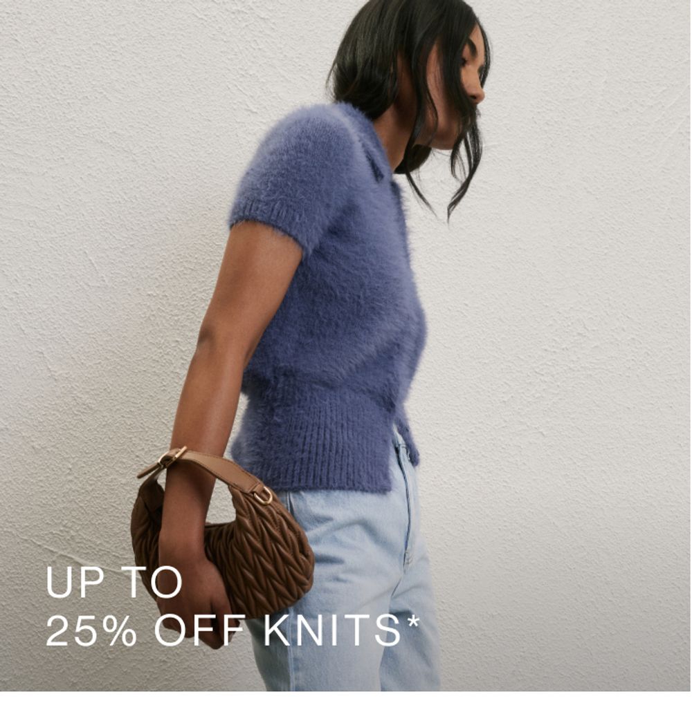 Model wearing a blue fluffy knit with light jeans and brown bag. SHOP 25% OFF KNITS.