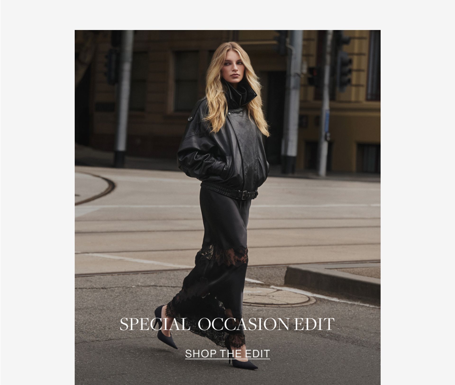 Model wearing a black leather jacket and black lace skirt. SHOP THE SPECIAL OCCASION EDIT.
