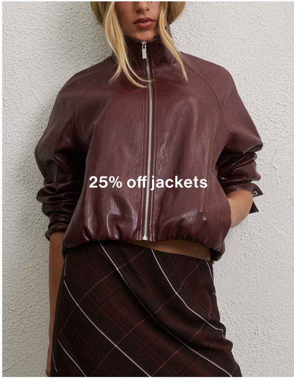 Model wearing a burgundy cropped jacket and skirt set, promoting 25% off jackets.