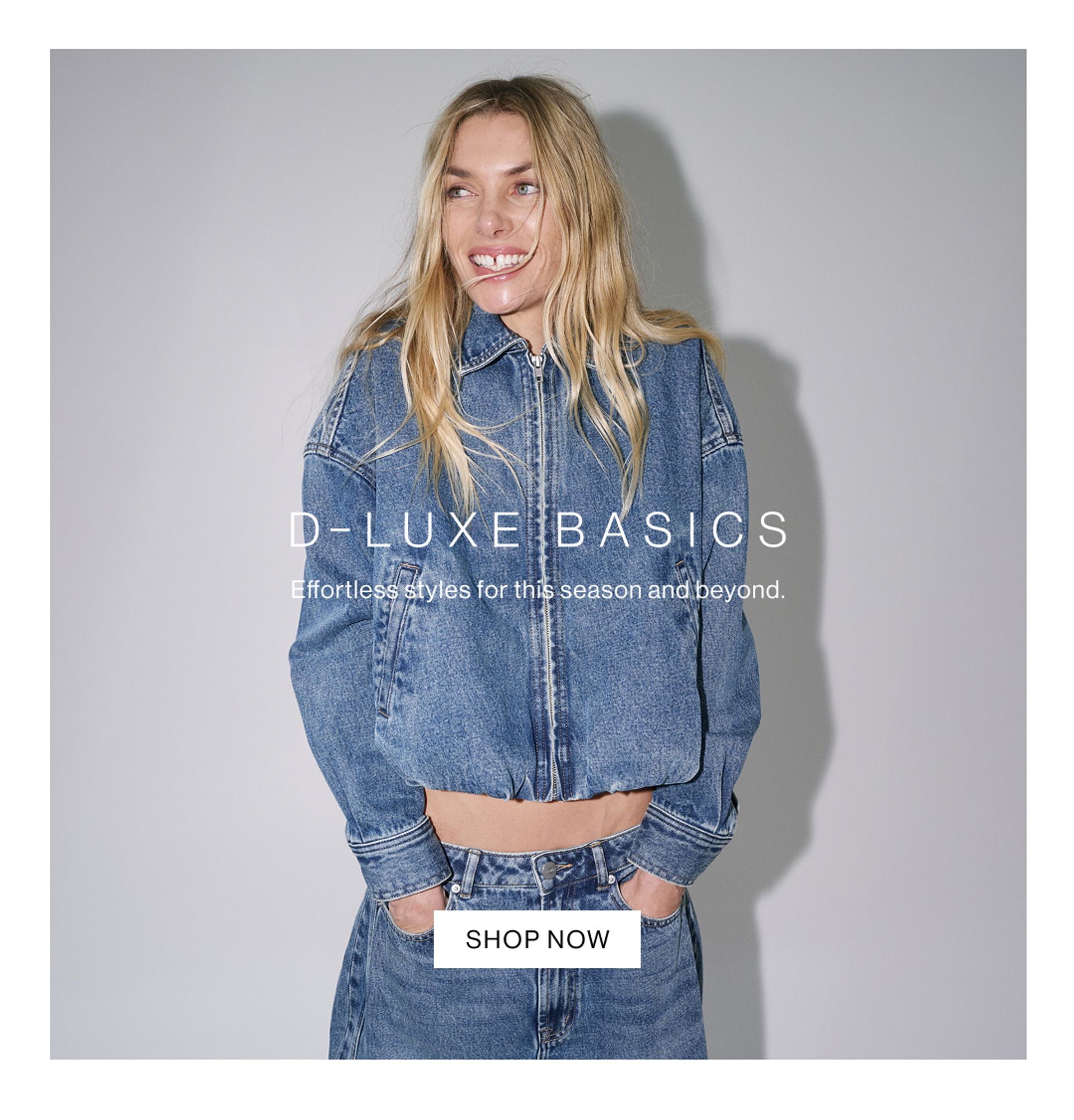 Blonde model smiling in a blue denim zip jacket and matching jeans – D-Luxe Basics.