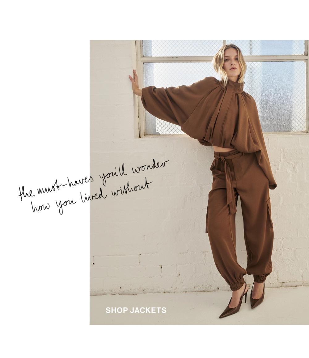 Model posing in a brown satin bubble jacket. SHOP JACKETS.