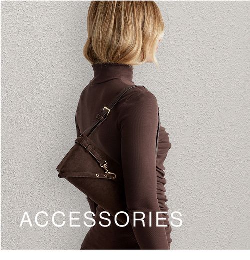 Model wearing a brown high neck long sleeve top with a brown shoulder bag. SHOP ACCESSORIES.