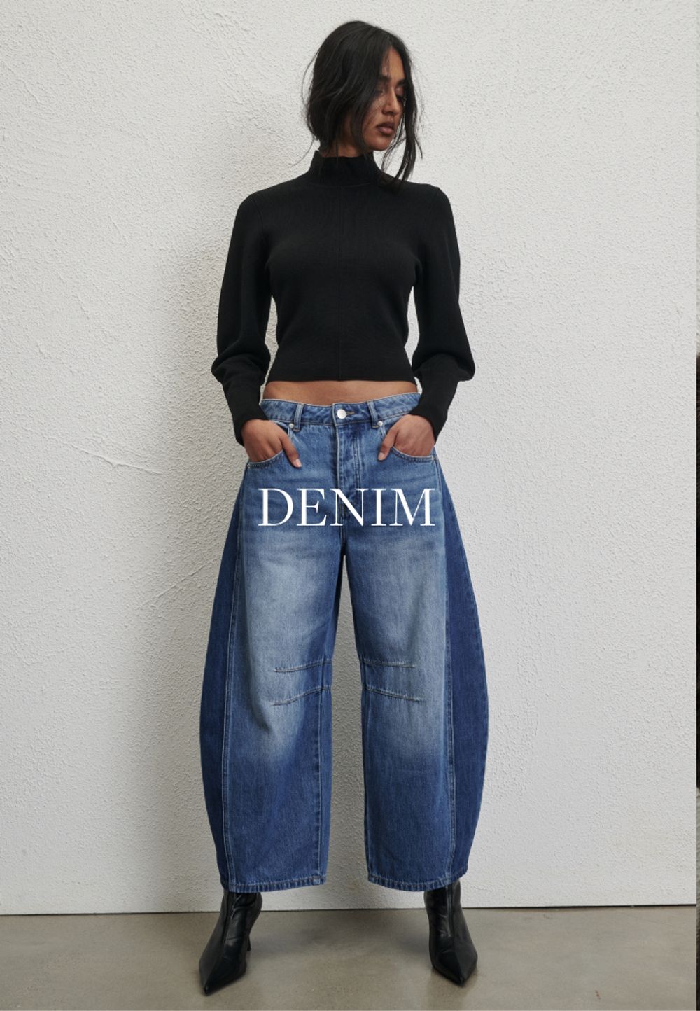 Model wearing a light denim jacket and jeans. SHOP DENIM.
