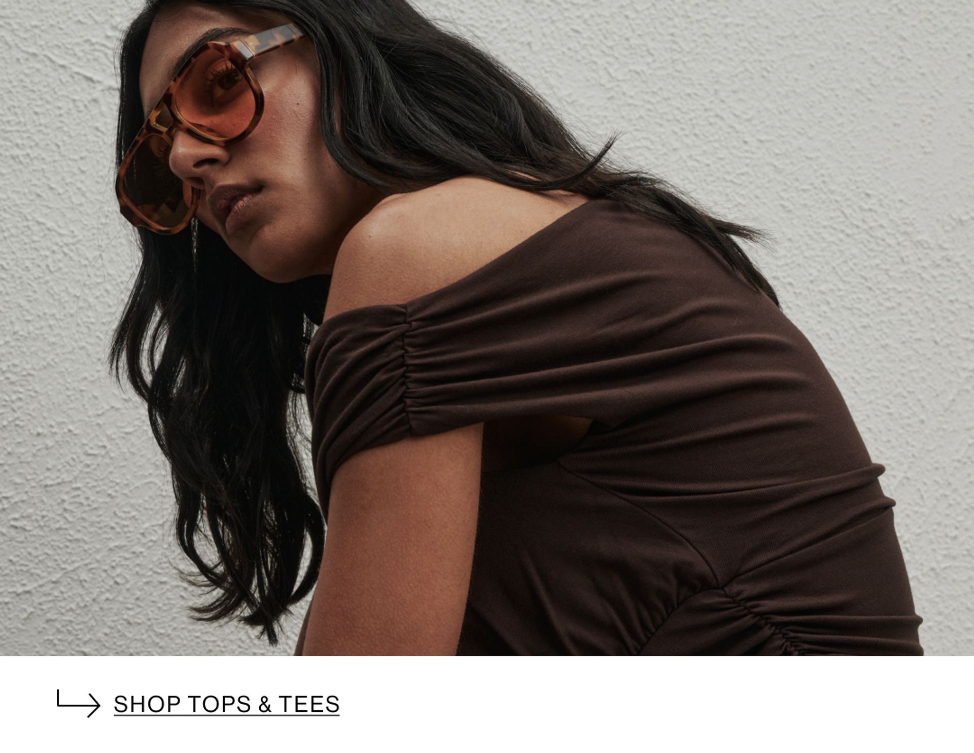 Woman in brown top and sunglasses