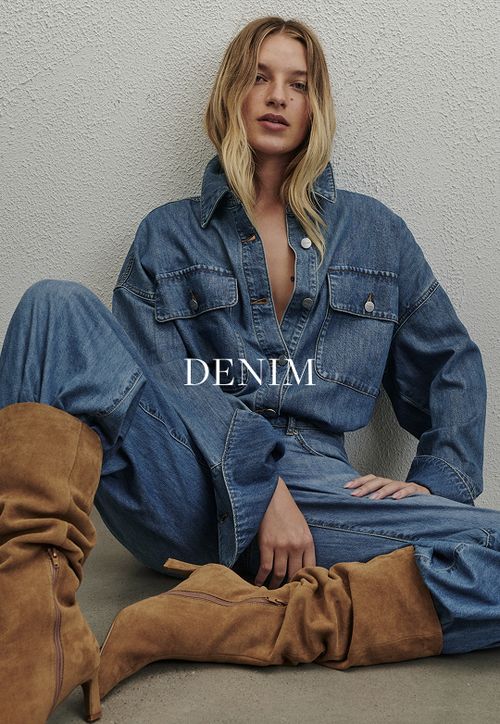 Model wearing a light denim jacket and jeans. SHOP DENIM.