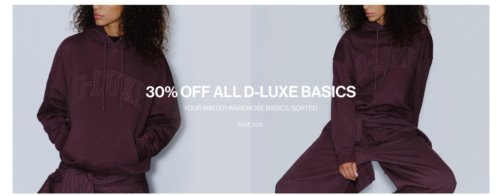 Model wearing a sweat set in midnight cherry in a studio. SHOP NEW D-LUXE.