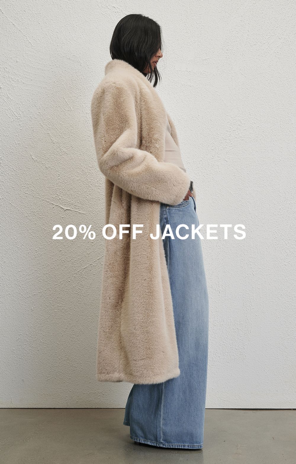 Model wearing a neutral faux fur jacket. Text reads 20% off jackets.