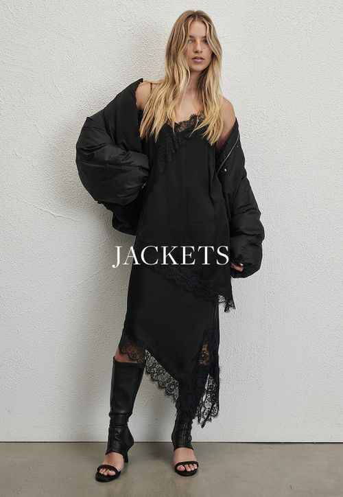 Model wearing a black jacket. SHOP JACKETS.