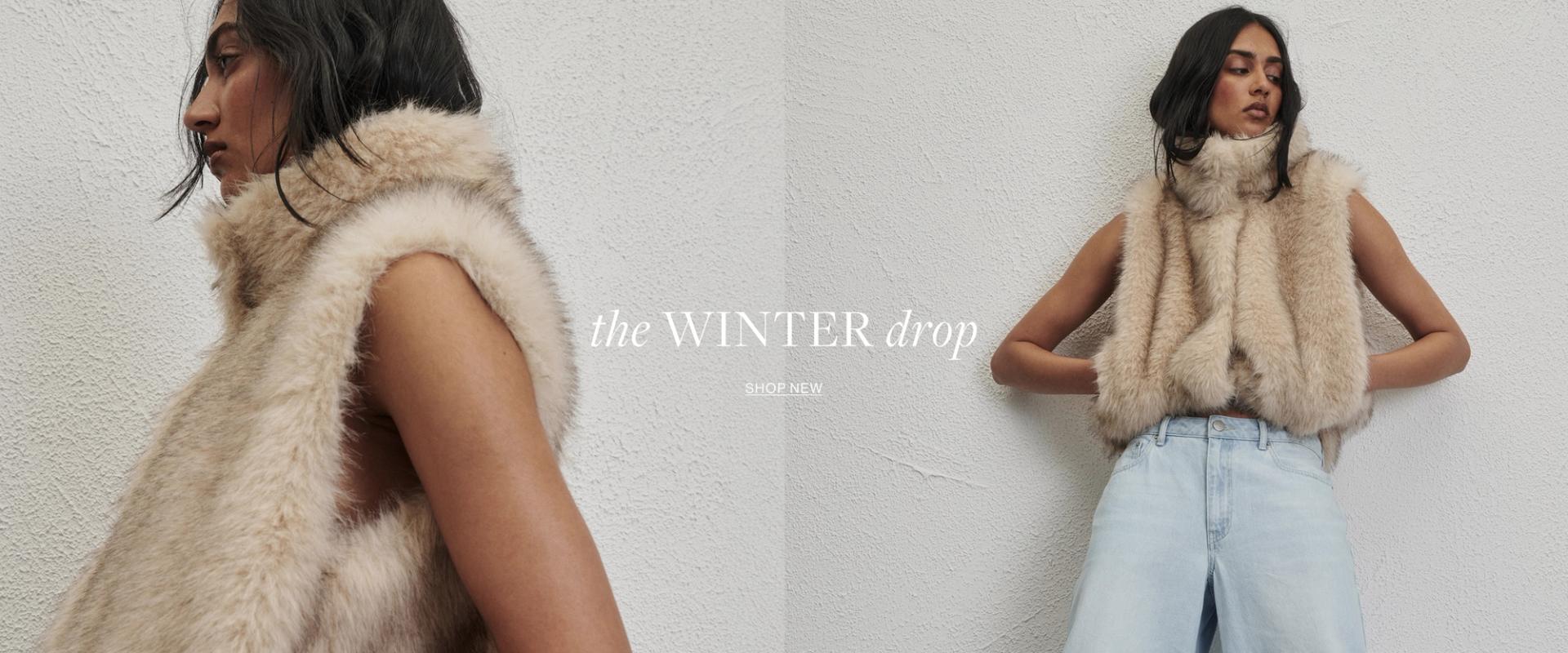 Woman posing in front of a white wall wearing a neutral Gilet with text the states "The winter drop shop now"