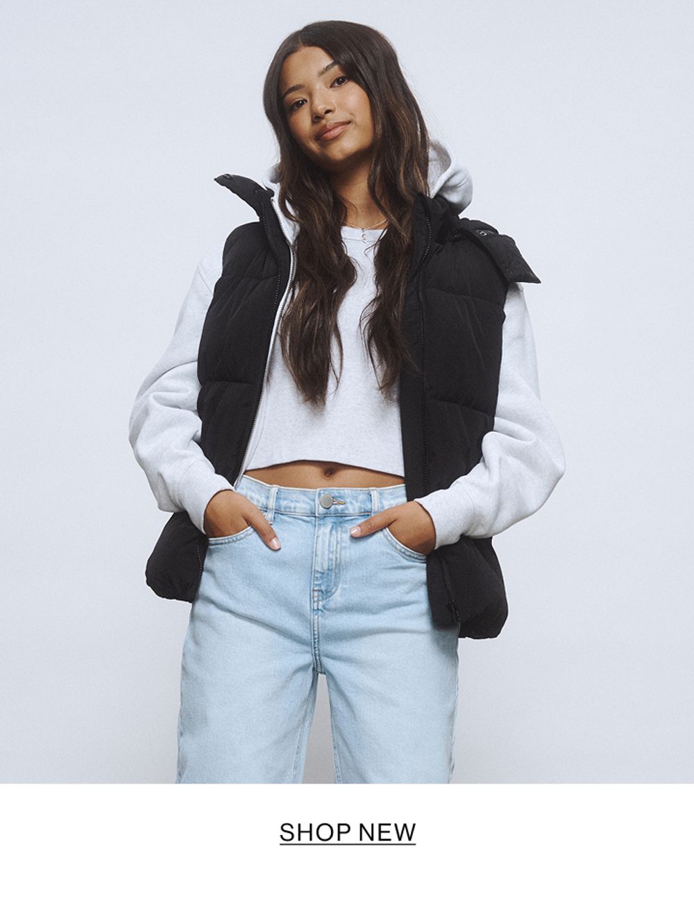 Young girl wearing a light blue denim jacket and skirt set.