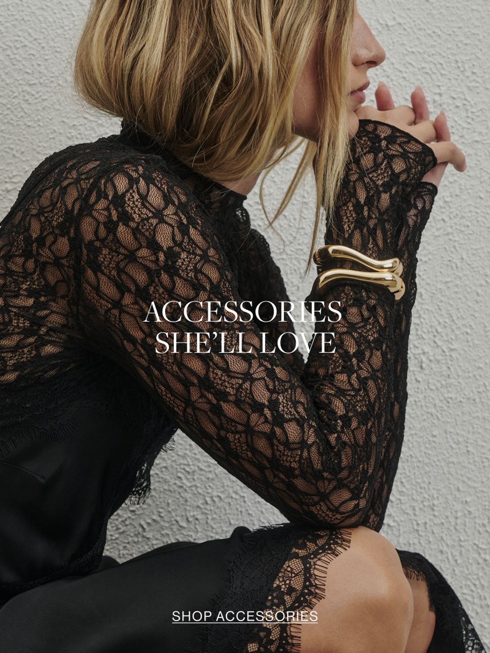 Woman in black dress and gold bangle. Text reads accessories she'll love