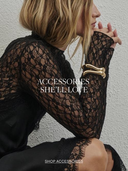 Woman in black dress and gold bangle. Text reads accessories she'll love
