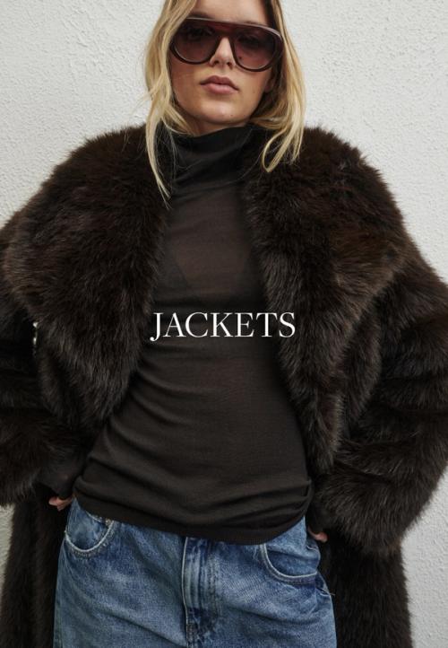 Woman sitting in front of a white wall wearing fur coat with text overlay which states "Jackets"