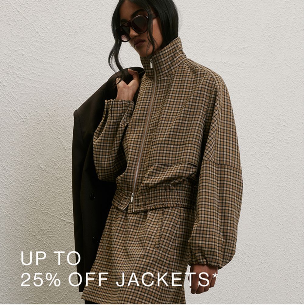 Woman posing in front of a white wall wearing a blue collared knit with text that states "25% off knits"