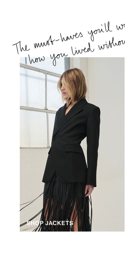 Woman standing in a black suit coat