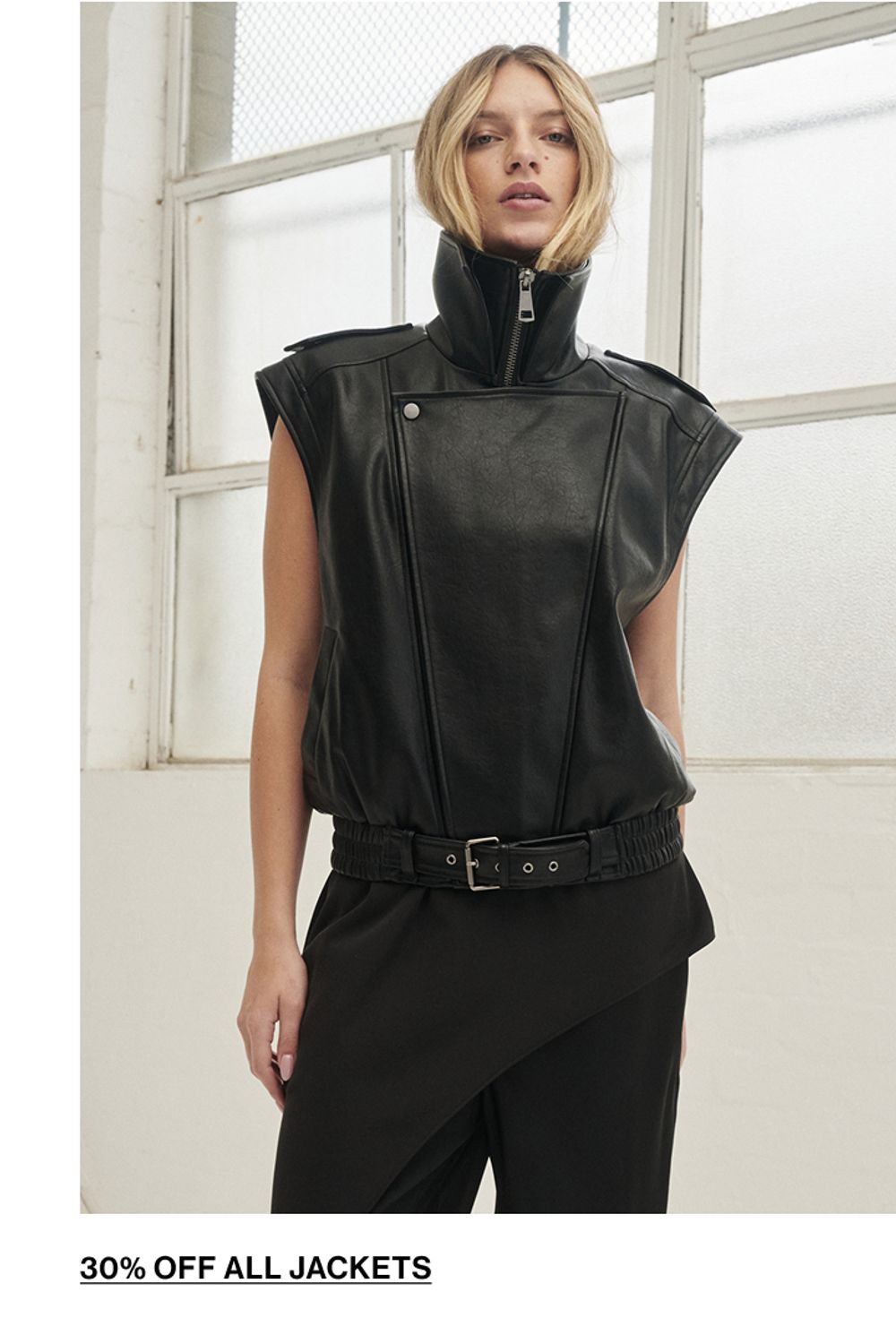 Woman standing in a black leather vest