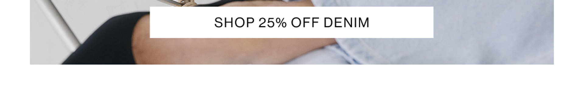 Woman staring at the camera laying in a modern chair wearing a matching denim set with text that reads shop 25% off denim