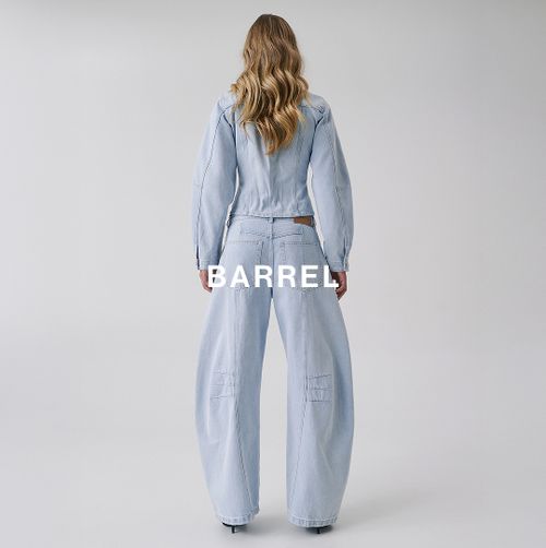 Woman standing backwards in a matching denim set with text overlay which states barrel