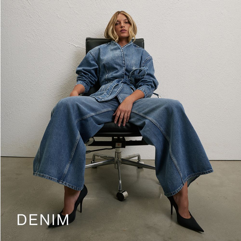 Woman sitting in a chair wearing a long sleeve denim set with text overlay which states "Denim"