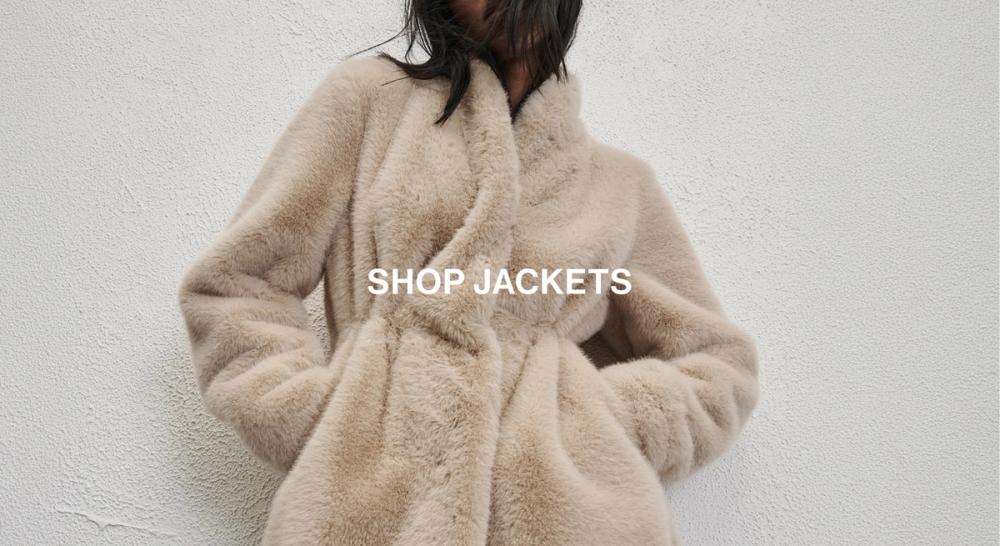 Woman sitting in front of a white wall wearing cream fur jacket with text overlay which states "20% off Jackets"