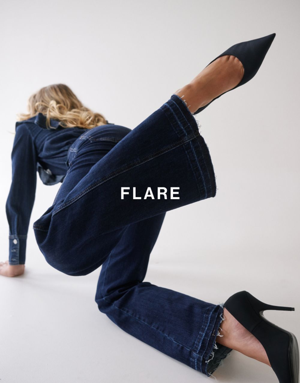 Model in a modern pose, wearing a matching denim set which has text overlay flare