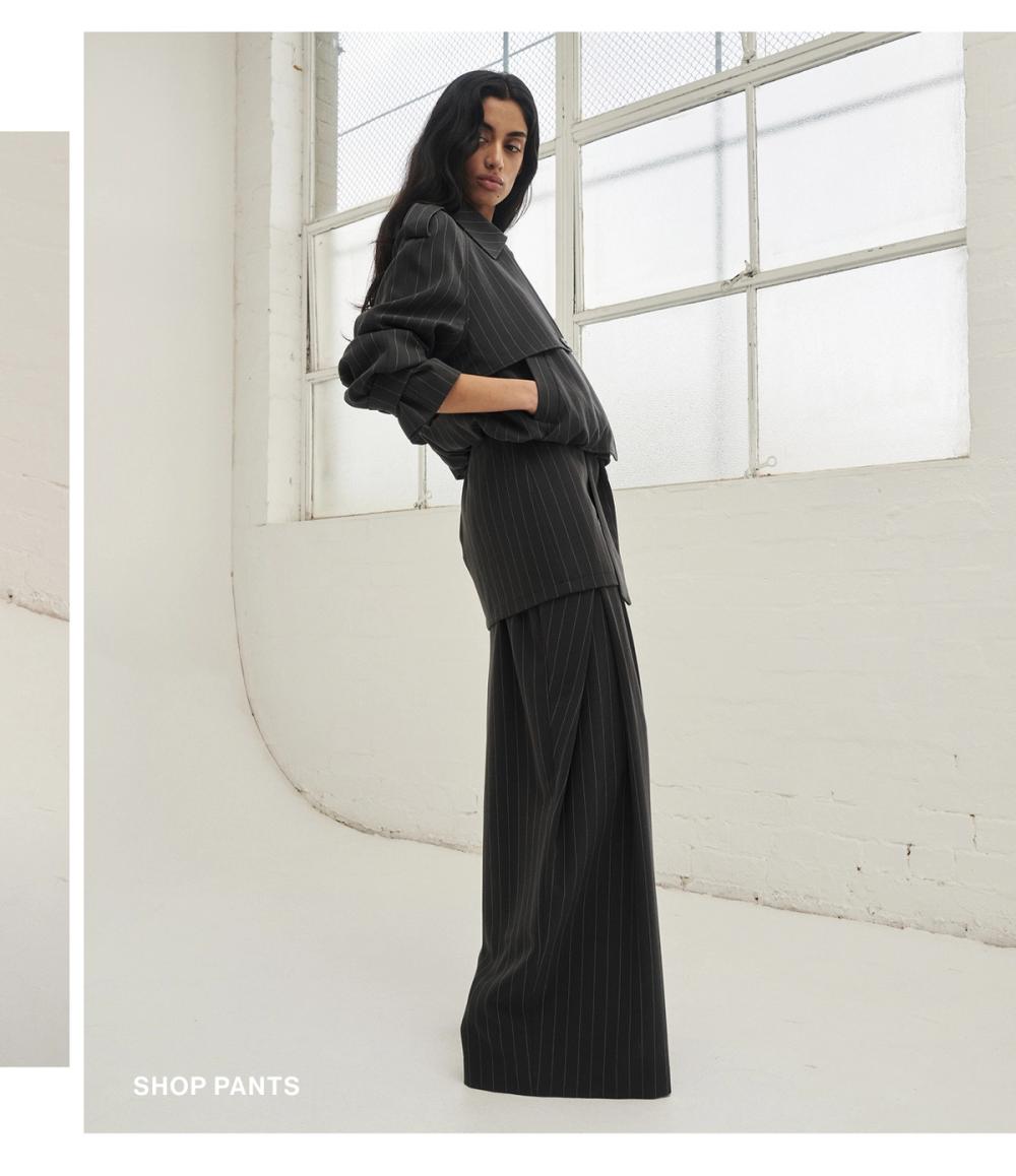 Woman posing in a grey suit