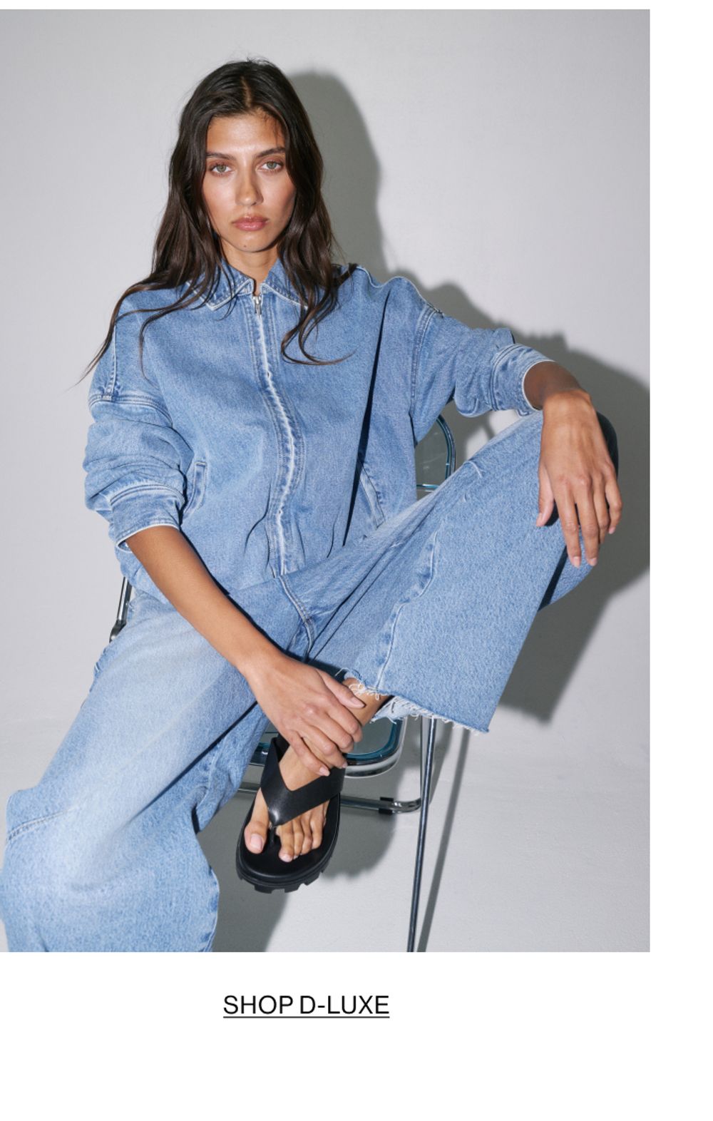 Woman posing in double denim with text that states shop Dluxe